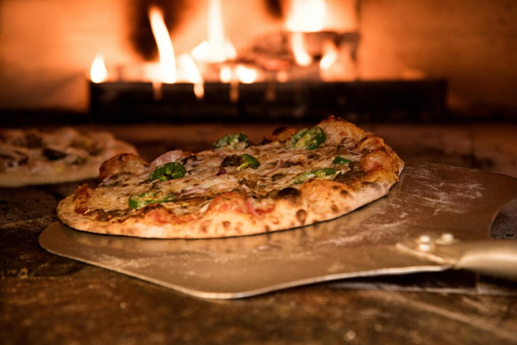 pexels-photo-905847-905847 Appetizing gourmet pizza cooked in a wood-fired oven, showcasing artisanal toppings.